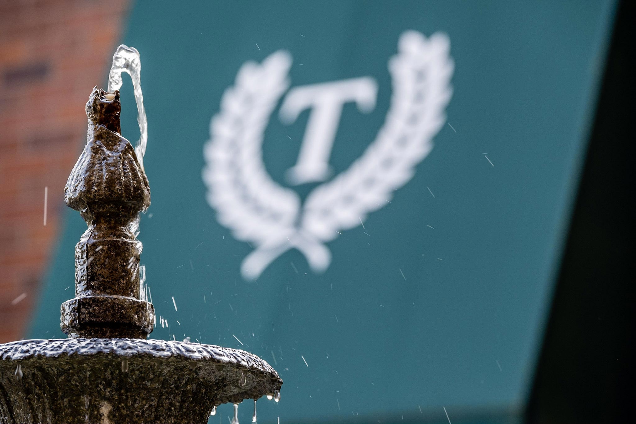 A fountain in front of a Treyton Oak Towers awning